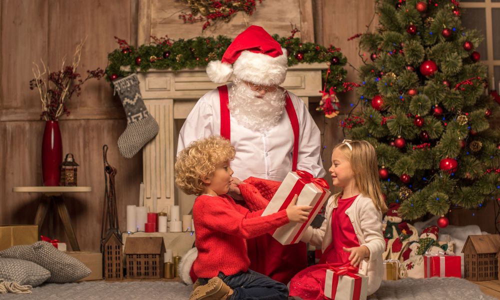Father Christmas giving gifts to two children.