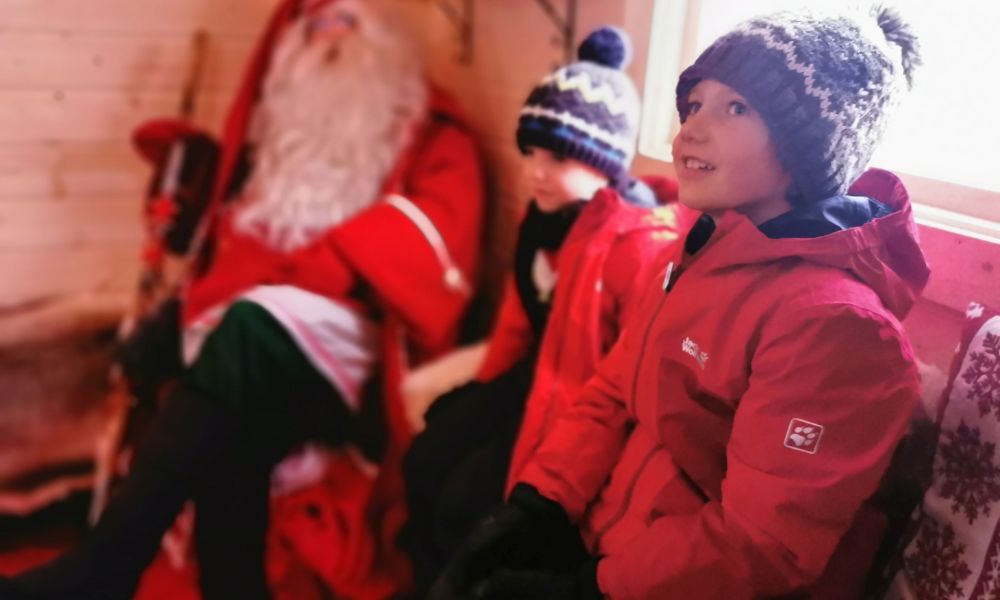 Children visiting Father Christmas at a Santa's Grotto.