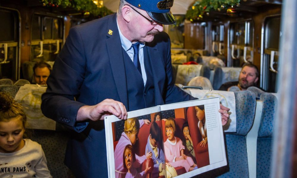 Conductor showing images from the Polar Express book on the Cholsey and Wallingford Polar Express.