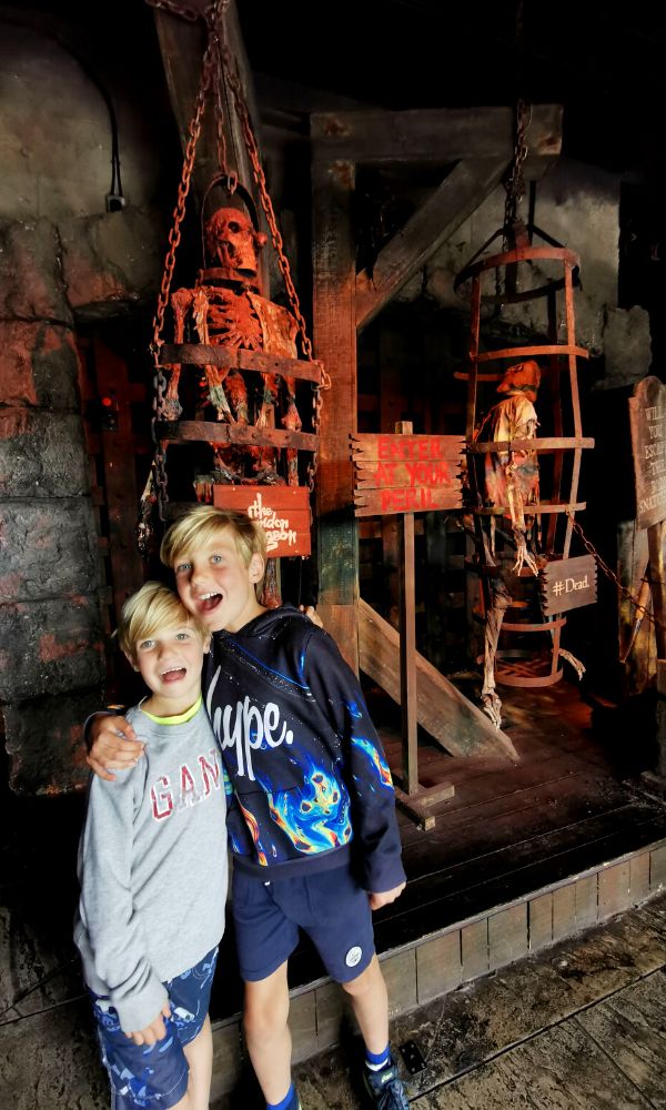 Two excited boys at the entrance of the London Dungeon.