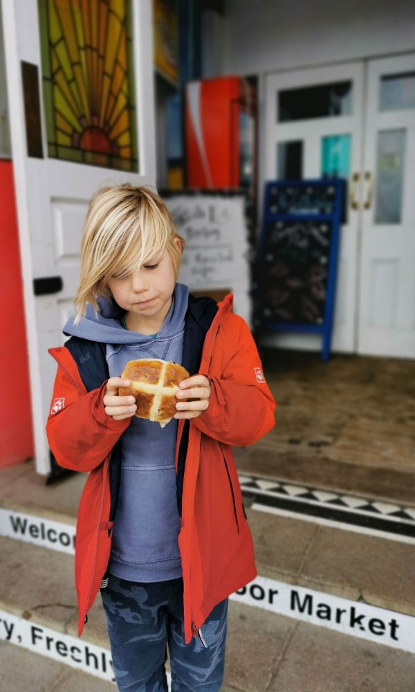 Boy enjoying a hot cross bun from Gina's Bakery in Margate.