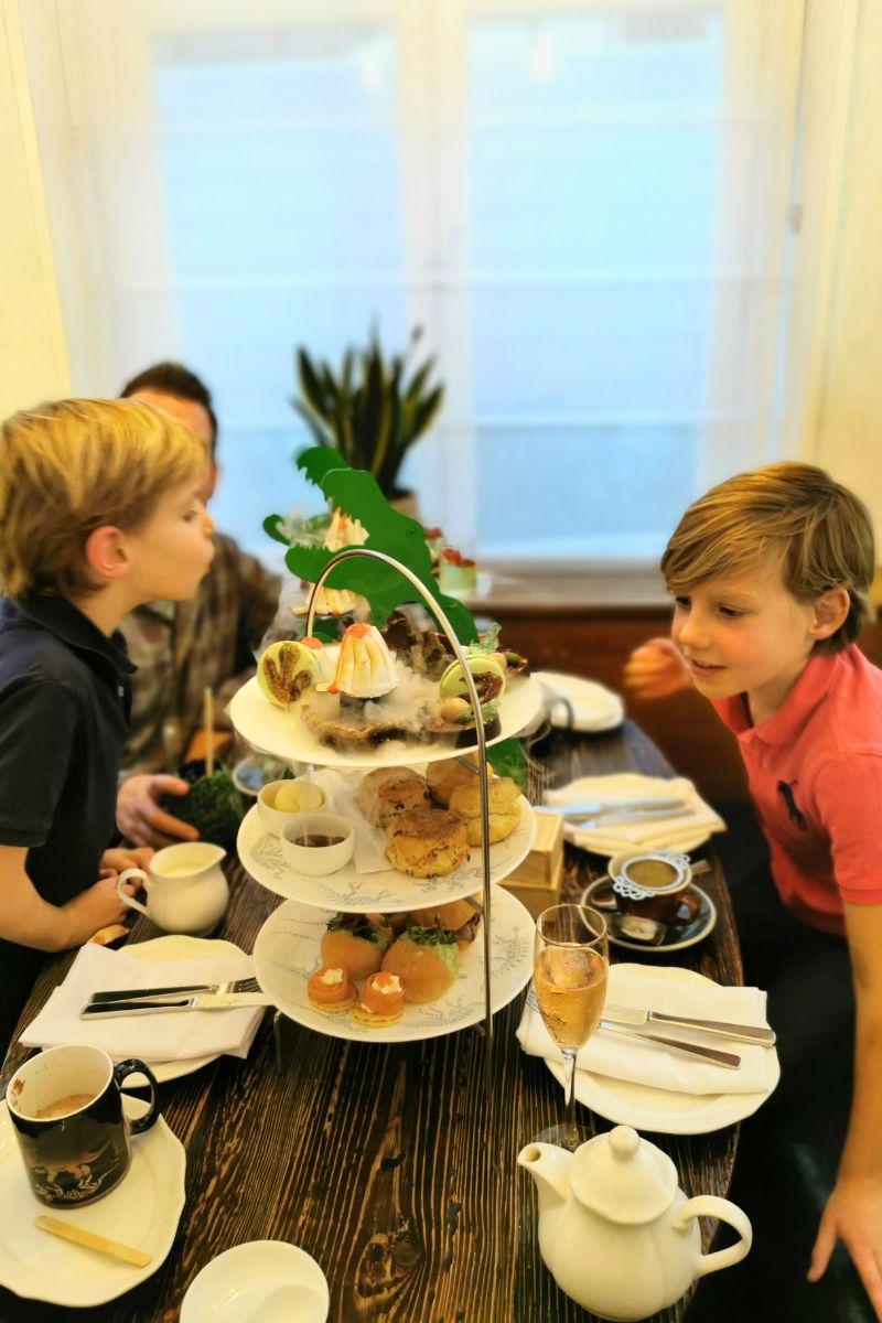 Family enjoying the Jurassic Afternoon Tea at the Ampersand Hotel in London - one of the best afternoon teas in London for kids we've ever tried.