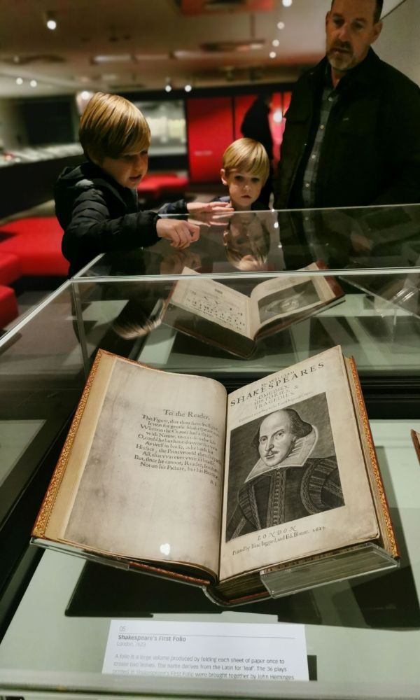 Family looking at a copy of Shakespeare's First Folio in the British Library in London.