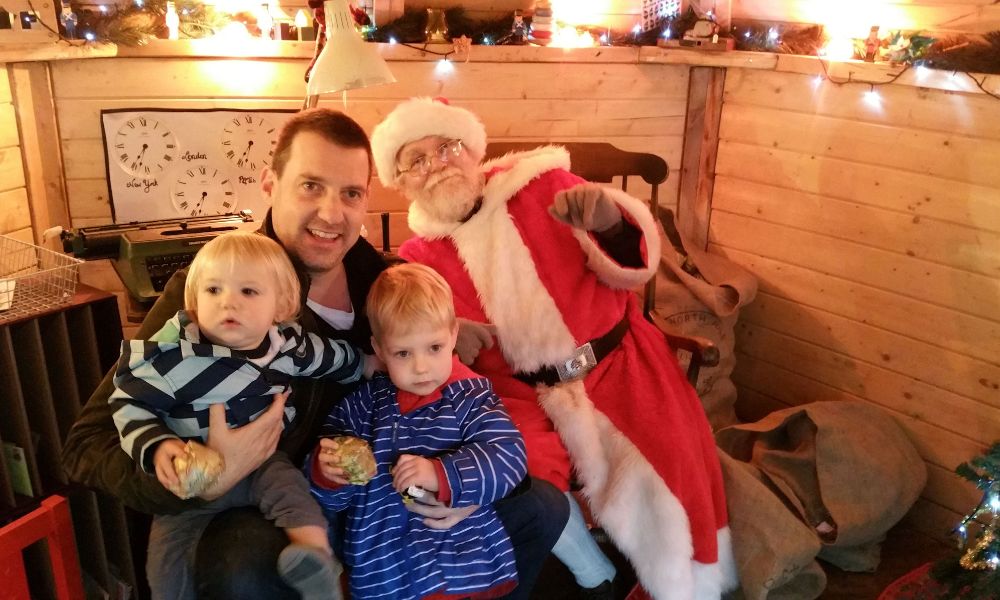 Family visiting Father Christmas in his grotto - one of the best things to do with kids at Christmas in Essex. 