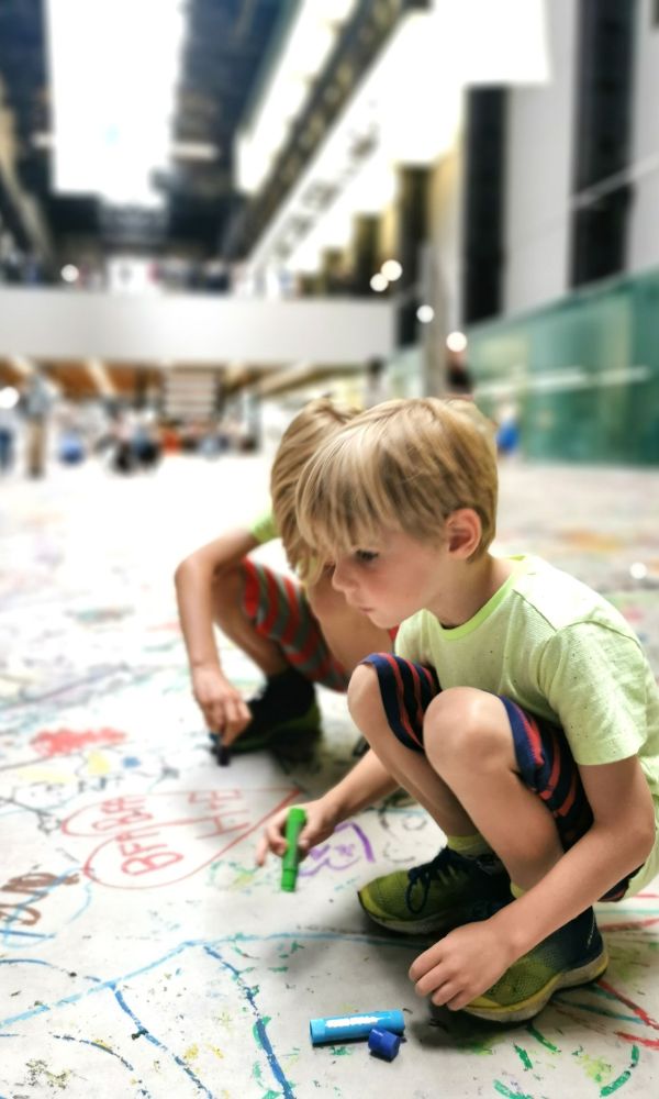 Kids drawing on the floor of the Tate Modern in London.