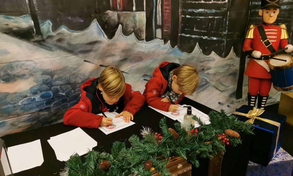 Kids writing letters to Father Christmas at a Christmas event in Essex.