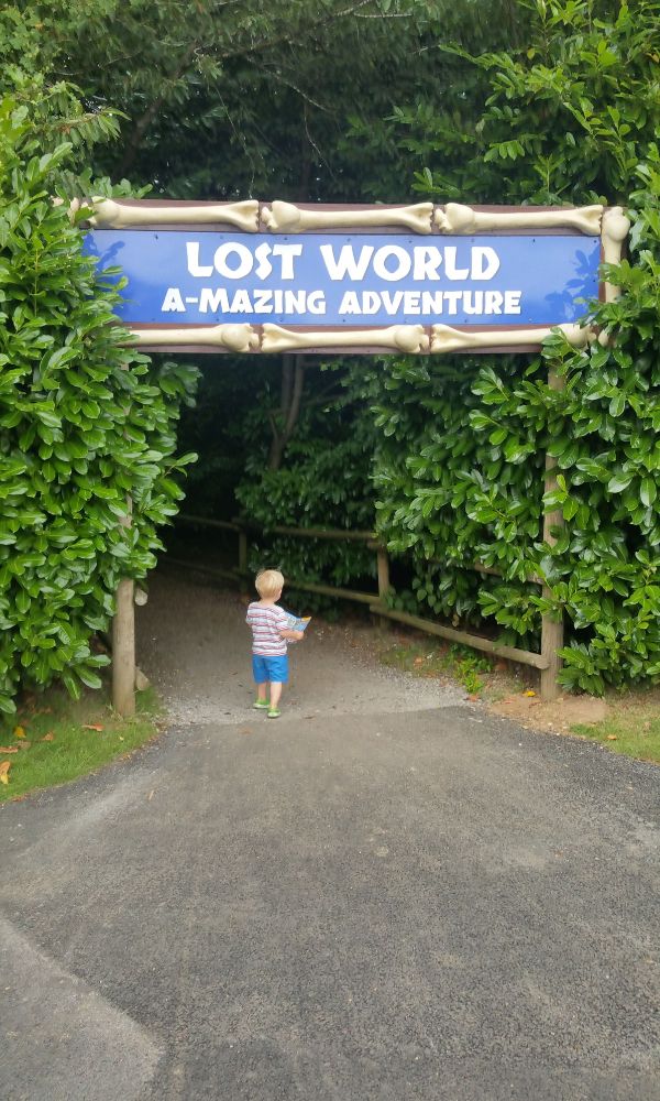 Young child entering the Lost World A-Mazing Adventure at Roarr Dinosaur in Norfolk - one of the best dinosaur days out in the UK.